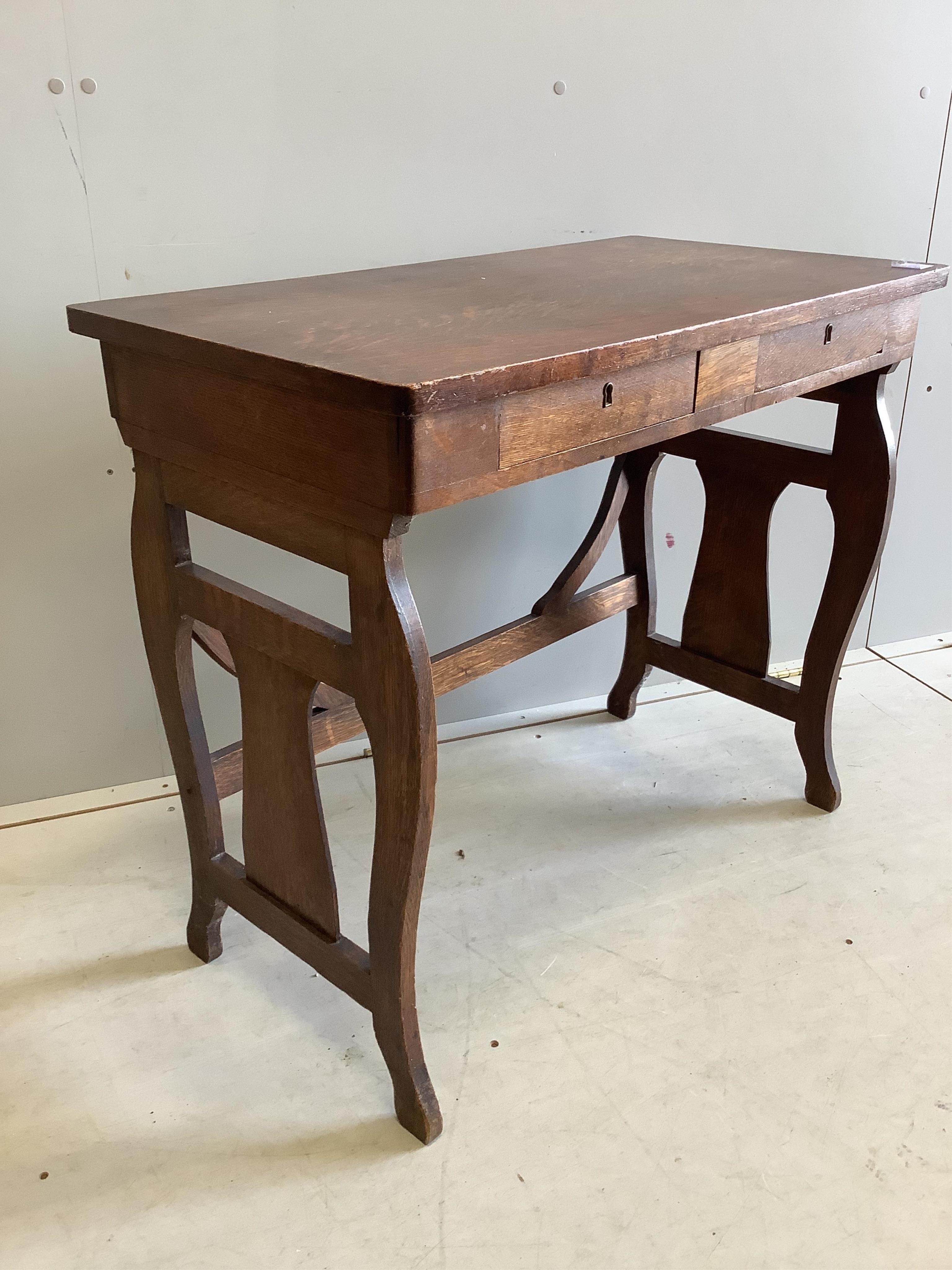 An early 20th century Continental oak two drawer side table, width 82cm, depth 44cm, height 72cm. Condition - fair
